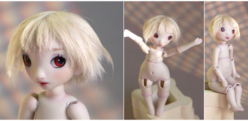 charming little doll with red eyes and a platinum blonde pixie cut