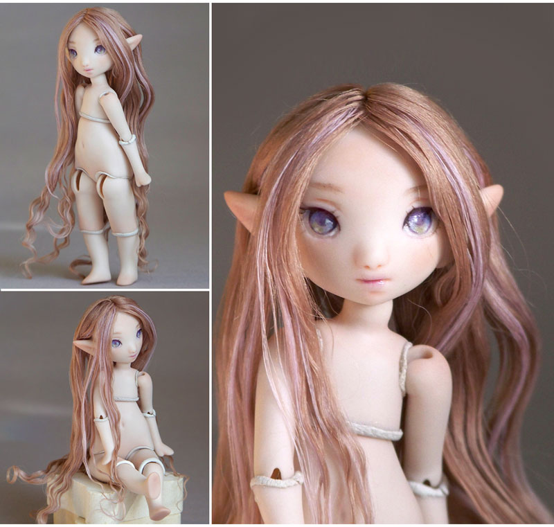meka elf doll with purple eyes and long strawberry blonde hair with streaks of lavender