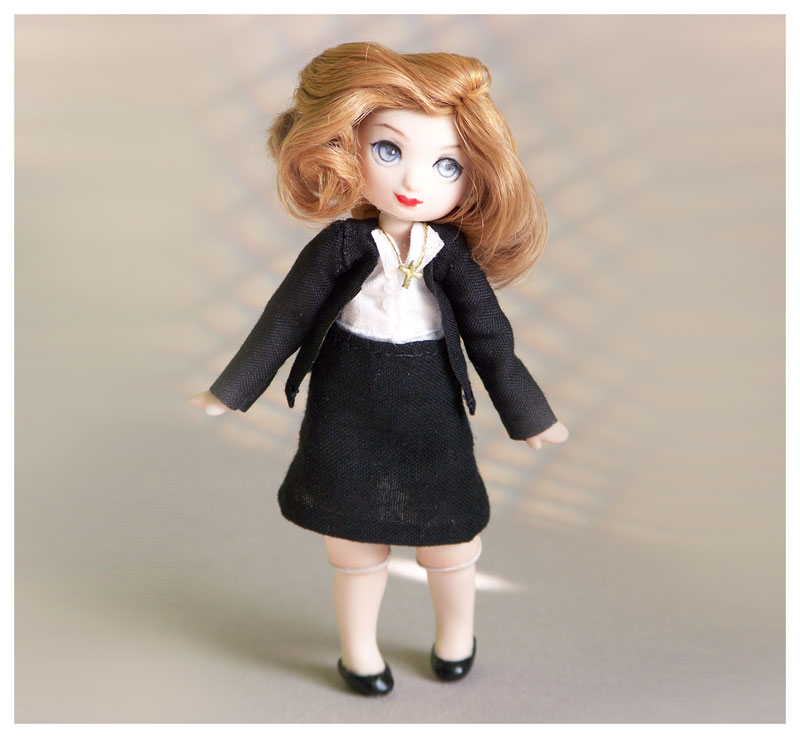 a meka doll dressed up and styled to look like dana scully from the x-files
