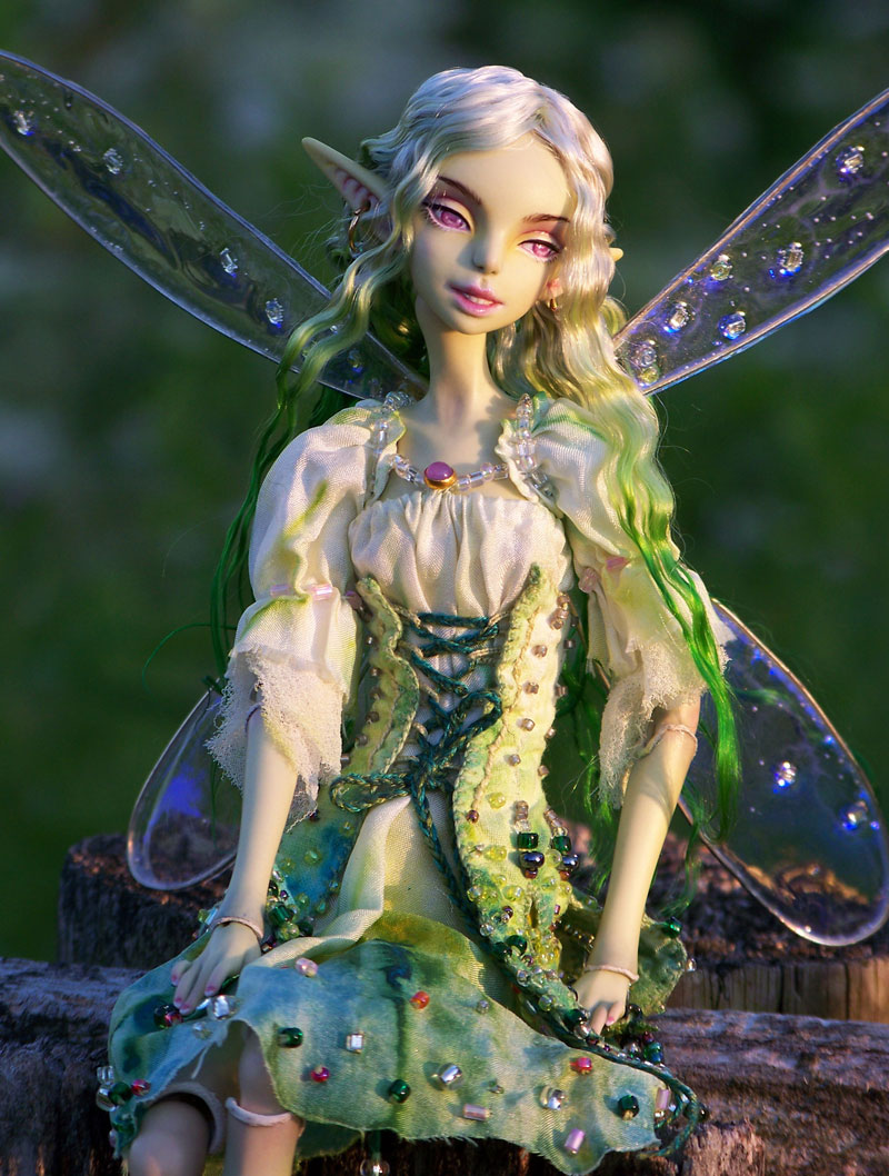 Green fairy doll in a silk dress with corset.